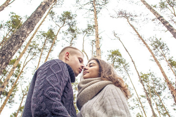 A guy and a girl look at each other embracing and holding hands. A young couple. St. Valentine's Day.