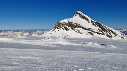 Mount Oldenhorn and ski slope on the Diablerets glacier, Switzerland. Clear blue winter day.