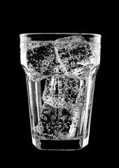 Glass of sparkling water soda drink with ice