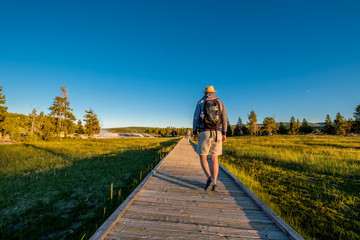 Tourists with backpack hiking in Yellowstone