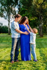 Fototapeta premium Happy pregnant family of three expecting new baby