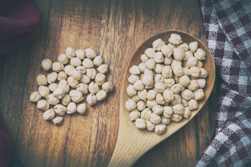 Wooden Scoop Full Of Chickpeas On A Wooden Surface