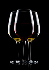 Glasses of red and white wine on black