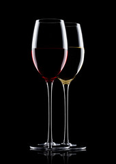 Glasses of red and white wine on black
