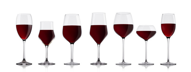 Glasses of red wine on white with reflection