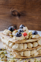 Homemade sugar free mille feuille with blueberries and pistachio
