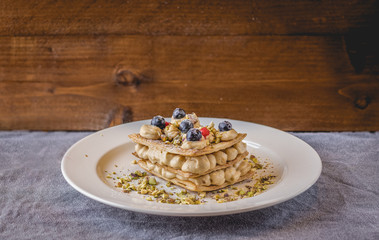 Homemade sugar free mille feuille with blueberries and pistachio