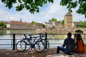 Two young people sitting on the embankment of the river ill in Strasbourg France