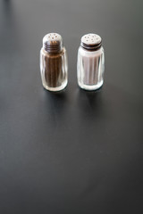 Salt and Pepper on Dark Grey Surface