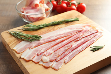 Rashers of bacon on wooden board