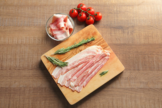 Rashers of bacon on wooden board