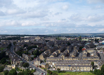 aerial view of halifax in yorkshire with the pennines on the horizon showing rows of houses and sky