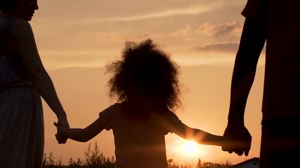 Happy young family looking forward to big bright future with joy, slow-motion