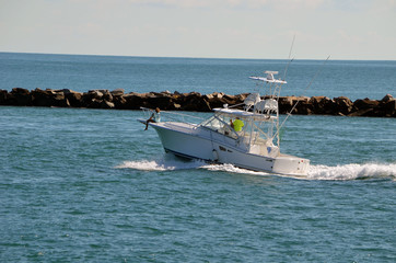 Sport fishing boat headed out to sea for a sunset pleasure cruise.