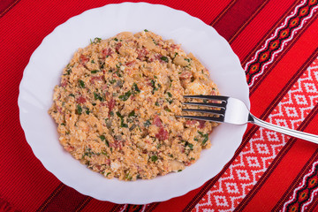 Traditional Bulgarian vegetable dish mish mash with mixed baked peppers, tomatoes, cheese, onion and scrambled eggs
