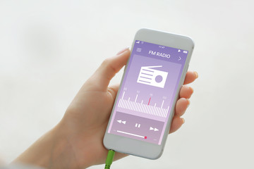 Female hand holding smartphone, closeup
