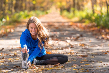 Woman exercising on autumn trail