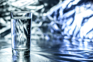 Glass of water on abstract background
