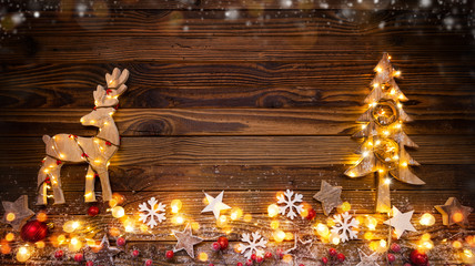 Christmas background with wooden decorations,moose, tree and spot lights