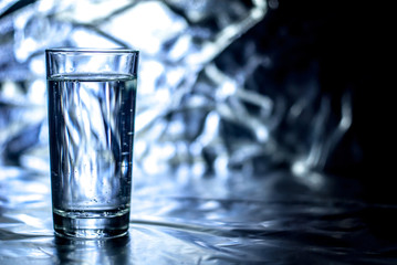 Glass of water with abstract background