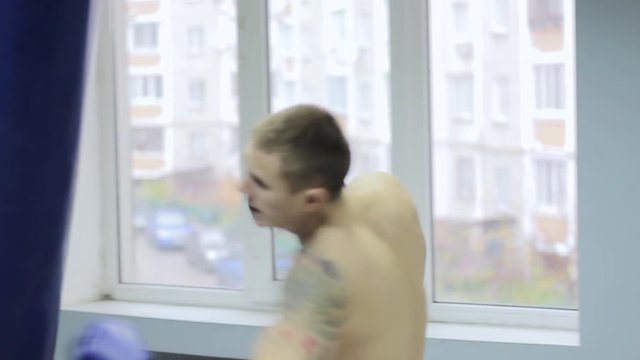 Young boxer with sports pear