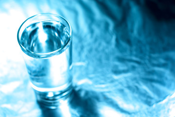 Glass of water in blue