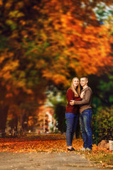 Fototapeta premium relationship between a girl and a guy. Golden autumn. a walk for two