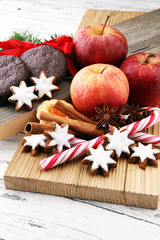 christmas cookies, apples, gingerbread and spice on white background