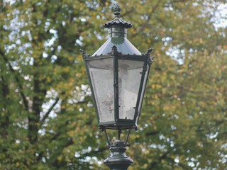 Old gas lanterns in Kaiserswerth Germany well maintained and still used ,trees in the background.