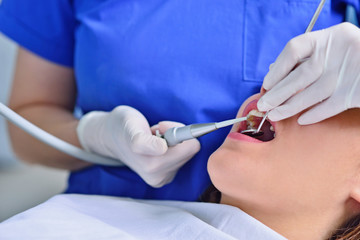 people, medicine, stomatology and health care concept - happy female dentist checking patient girl teeth