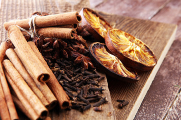 Dry orange slices, cinnamon sticks, anise and clove christmas spices decoration.