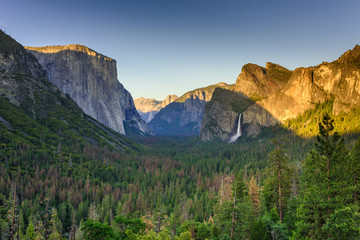 View of Yosemite Valley from Tunnel View point at sunset - view to Bridal veil falls, El Capitan and Half Dome - Yosemite National Park in California, USA