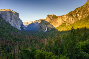 View of Yosemite Valley from Tunnel View point at sunset - view to Bridal veil falls, El Capitan and Half Dome - Yosemite National Park in California, USA