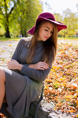 Lifestyle portrait of stylish blonde woman with natural makeup posing in red hat