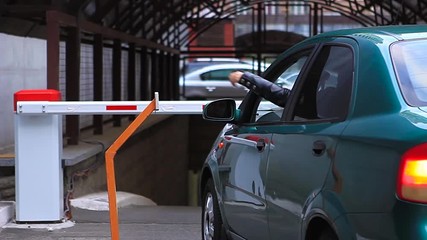 Driver open turnpike with safe key to parking the car underground