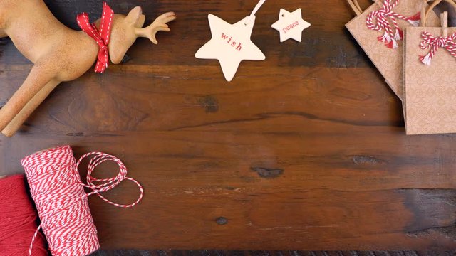 Christmas gift wrapping overhead in rustic theme with brown Kraft paper, string and natural ornaments, timelapse.