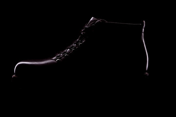 Silhouette of stylish black men shoe on black background