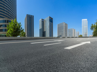 Fototapeta na wymiar empty road and modern office block buildings against sky, china.