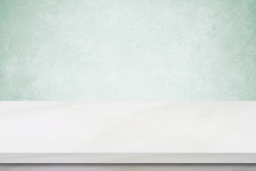 Empty white marble table over green cement wall background, copy space for product display montage