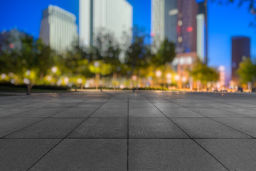 night view of empty brick floor front of modern building