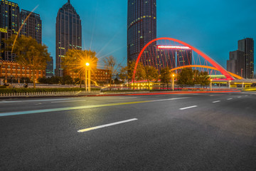 Fototapeta na wymiar Empty asphalt road through modern city at night, China.