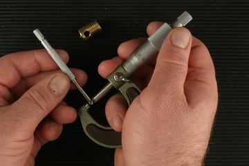 Metric Micrometer, Small hole gauge, black toolbox mat background, brass part