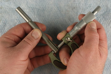 Metric Micrometer,  measuring chucking reamer, blue shop towel background