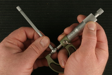 Metric Micrometer, telescoping gauge, black ribbed toolbox mat background