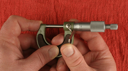 Metric Micrometer, zeroing, red shop towel background