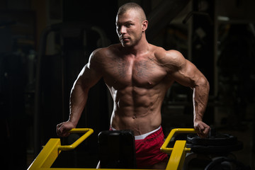 Muscular Man After Exercise Resting In Gym