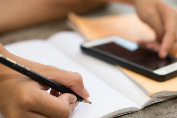 Male students are doing homework with intent. Search the Internet and in phone books. To prepare teachers.