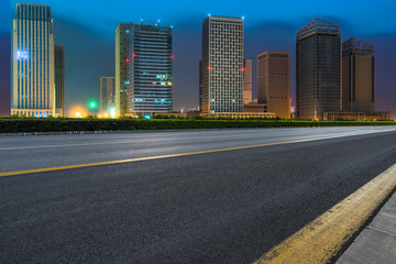 Fototapeta na wymiar night view of Empty asphalt road through modern city