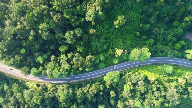 Aerial view. Moving cars on a winding road.