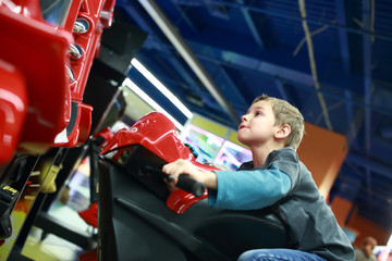 Kid playing in motorcycle simulator